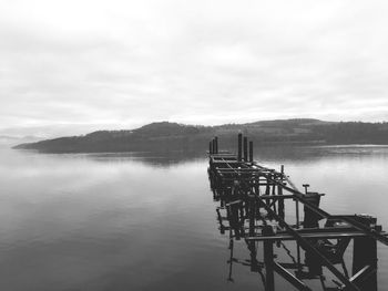 Scenic view of lake against cloudy sky