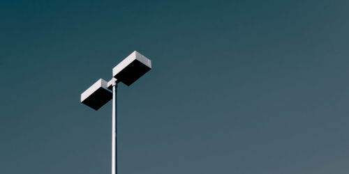 Illuminated lamp against clear sky