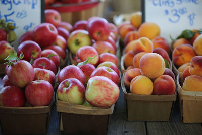 Apples and peaches for sale at an autumn farmer's market