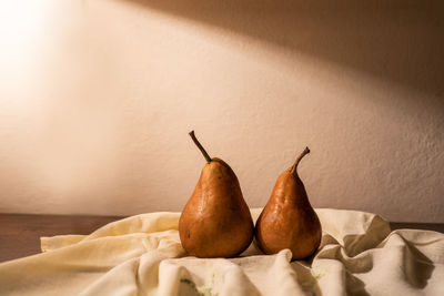 High angle view of fruits on table against white wall