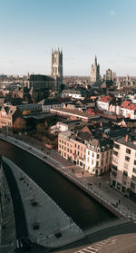 High angle view of bridge over river amidst buildings in city