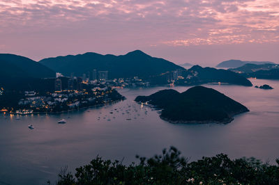 High angle view of sea and buildings against sky