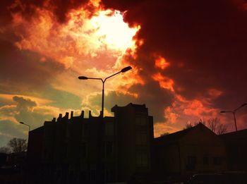 Silhouette of building against dramatic sky