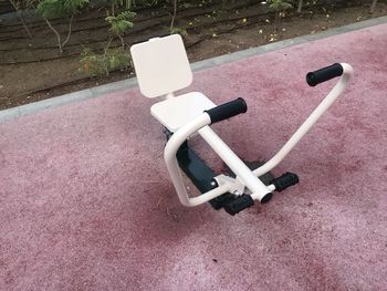 High angle view of empty chair in yard