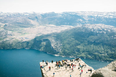 High angle view of people on rock formations against river