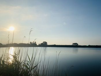 Scenic view of lake against sky during sunset