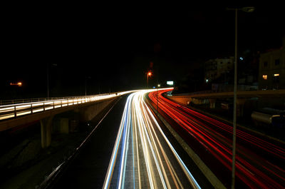 Light trails on road in city at night