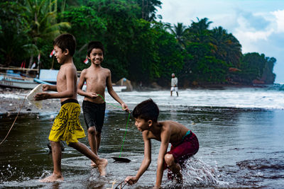 Full length of shirtless boy in water