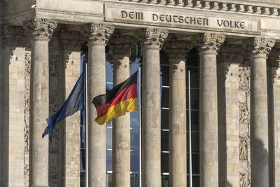 Low angle view of flags at historical building