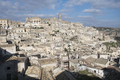 High angle view of buildings in town against sky