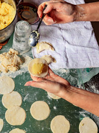 Midsection of woman preparing food in kitchen