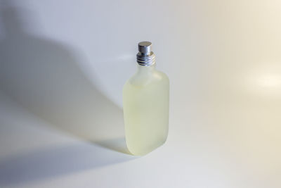 Close-up of glass bottle on white background
