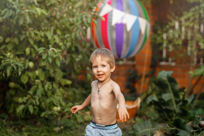 Portrait of cute boy standing outdoors