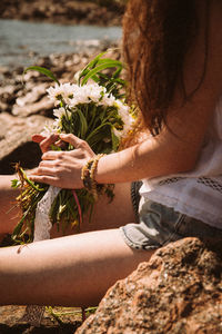Close-up of woman hand holding flowers