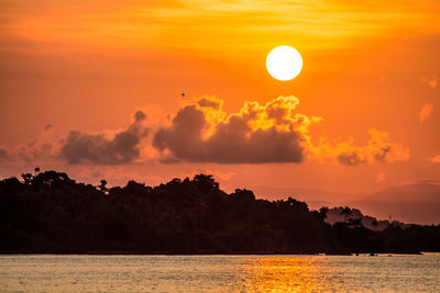 Scenic view of sea against orange sky