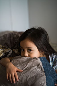 Cute girl relaxing on bed at home