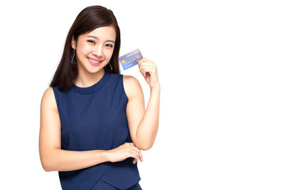 Portrait of a smiling young woman against white background