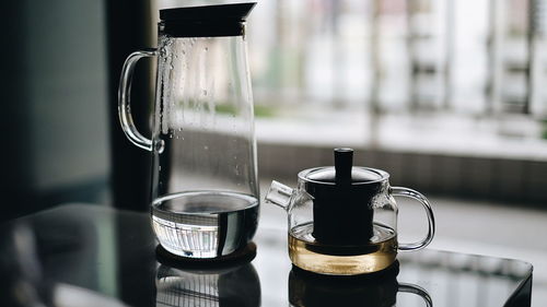 Close-up of coffee maker and jug on table