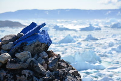 Close-up of blue painted rocks during winter