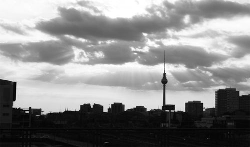 City skyline against cloudy sky