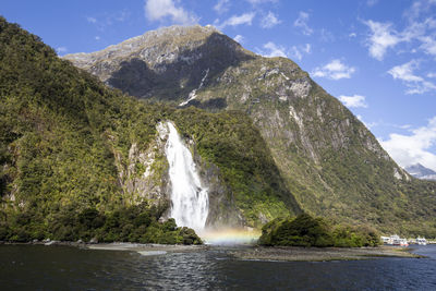 Scenic view of waterfall against sky