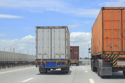 Vehicles on road against sky