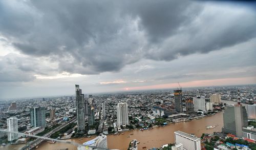 High angle view of cityscape against cloudy sky