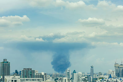 Huge explosion and fire at plastic factory on outskirts of town, thick black smoke filled sky
