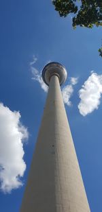 Low angle view of tower against cloudy sky