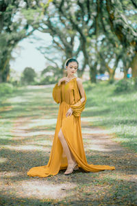 Portrait of woman standing on field