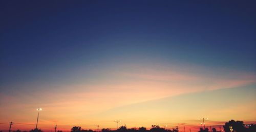 Silhouette buildings against sky during sunset