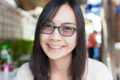 Close-up portrait of smiling young woman