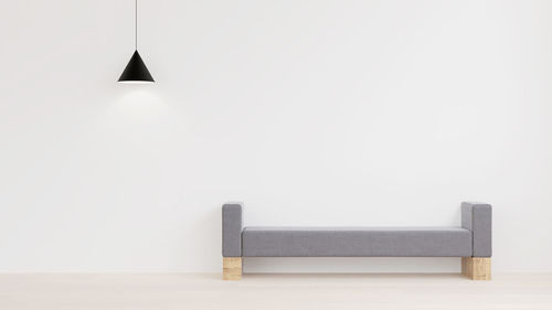 Empty seat with pendant light against white background