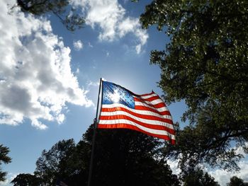 Low angle view of american flag against blue sky