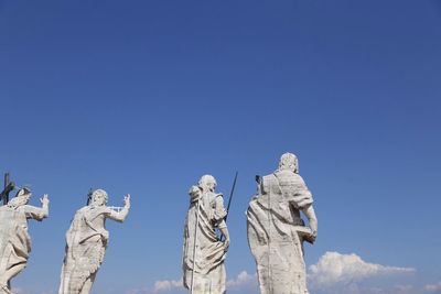 Statues on st peter basilica against sky