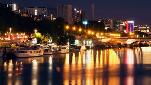 Seine river colored by the street lights reflecting on its surface at  dusk