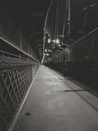 Illuminated bridge walkway at night