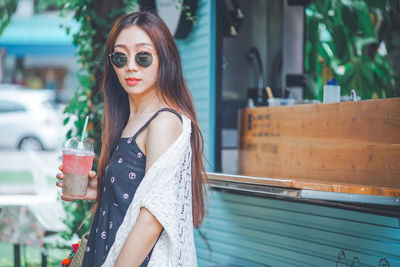 Portrait of young woman standing outdoors