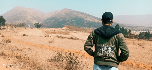 Rear view of man looking at mountains