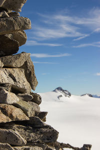 Low angle view of stack of rocks against sky