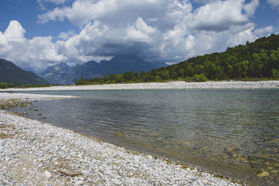 Scenic view of sea and mountains against sky