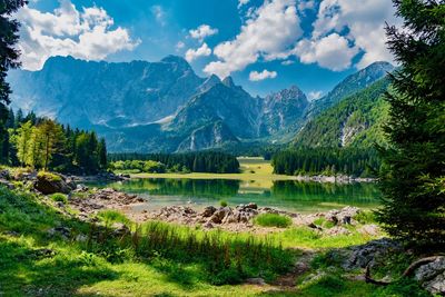 Scenic view of lake and mountains against sky