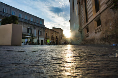 Surface level of street by buildings against sky