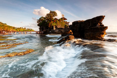 Scenic view of waterfall against sky