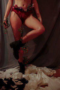 Low section of woman wearing panty and plants