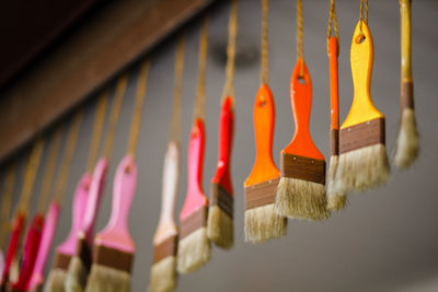 Close-up of clothespins hanging on wall