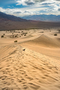 View of desert against cloudy sky