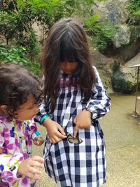 Cute girls looking at butterfly