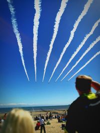 People enjoying against blue sky