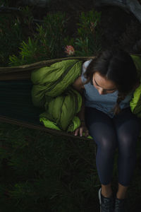 High angle view of woman sitting on plant